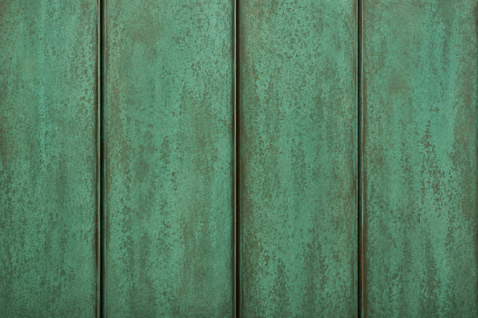 Weathered teal wooden fence boards with vertical panels and dark seams