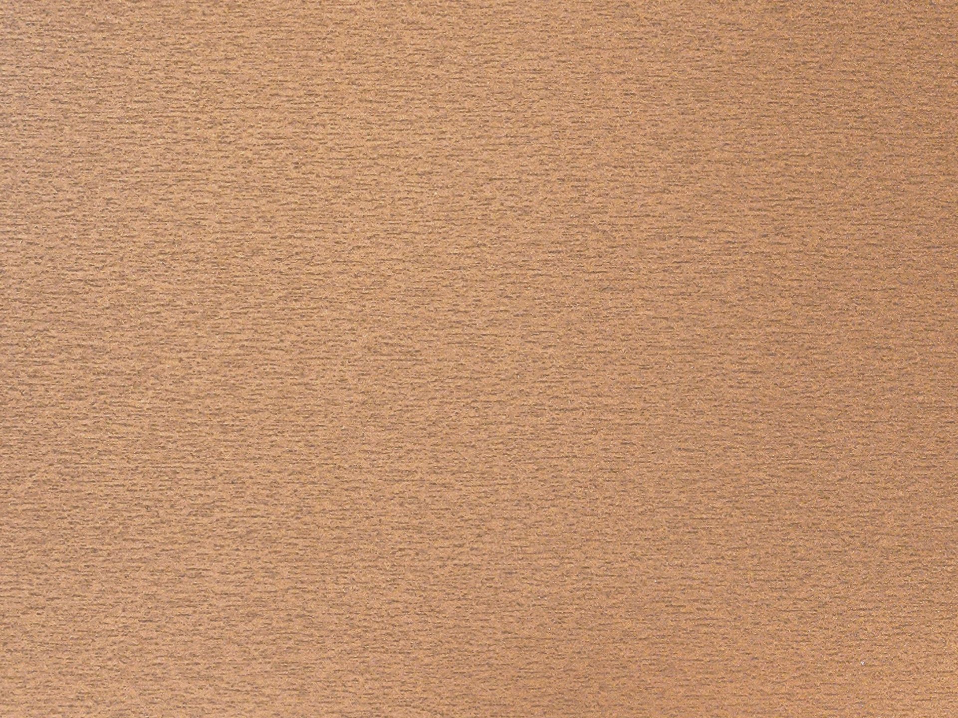 Close-up of a tan, textured fabric surface with a subtle woven pattern
