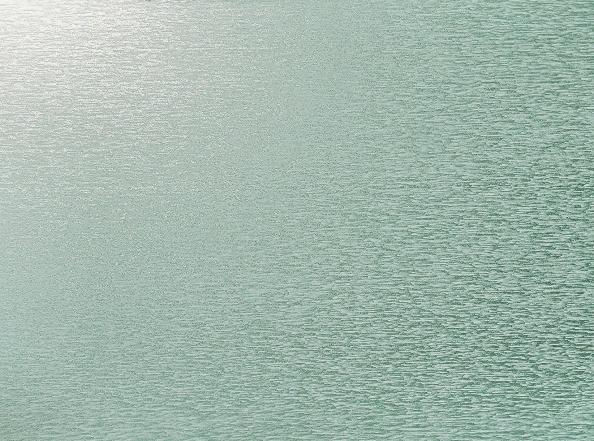 Close-up of pale green water with small ripples and a soft textured surface