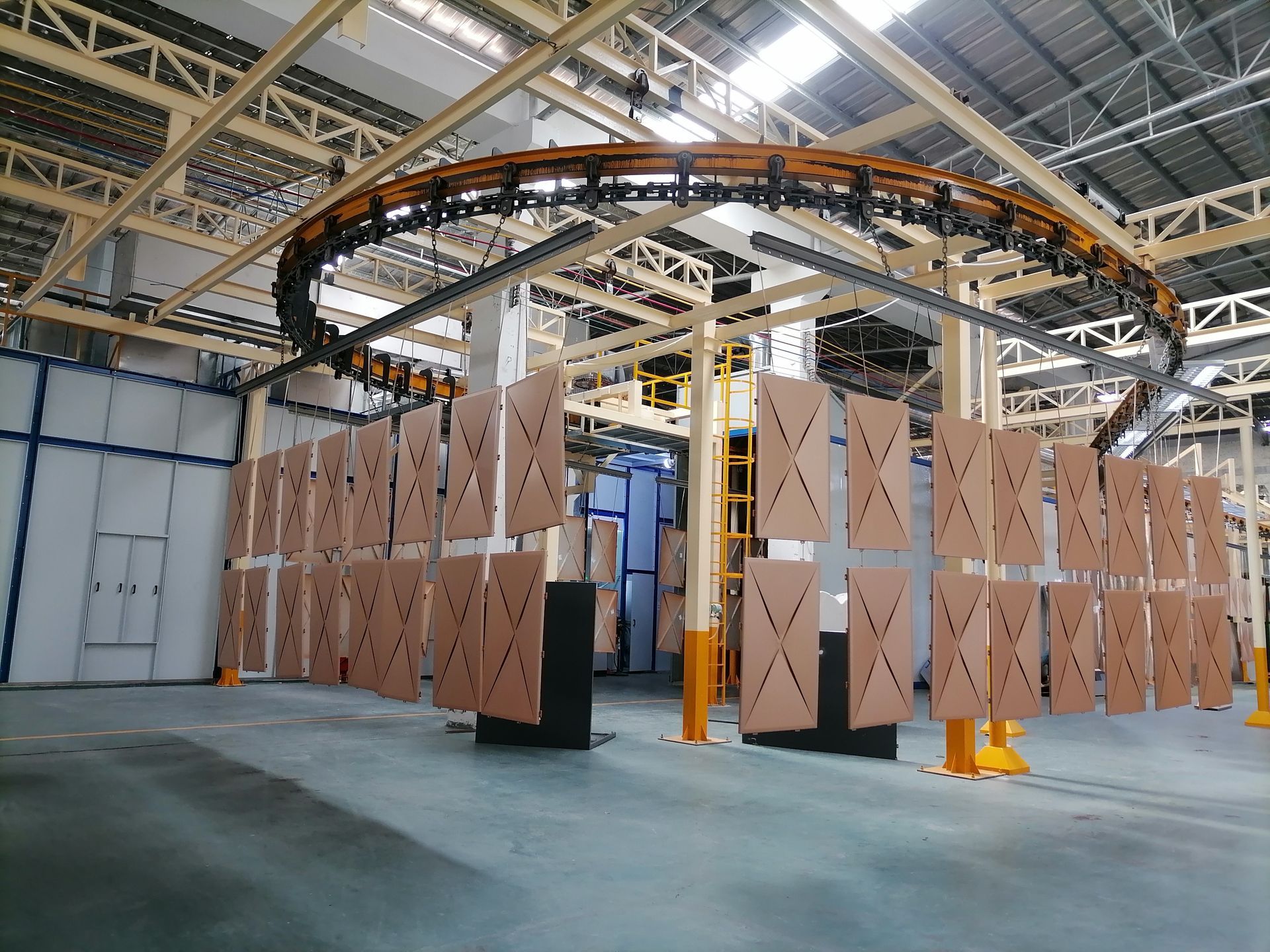 Industrial warehouse with a circular conveyor system and tall stacked boxes in a spacious factory interior