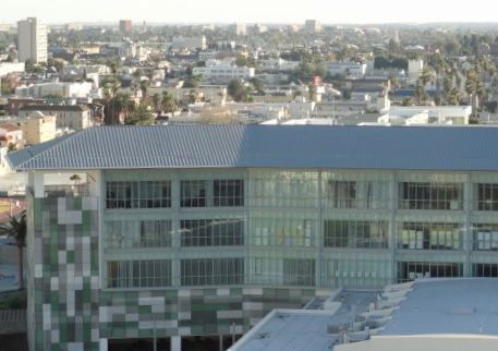 Modern glass office building with a city skyline in the background
