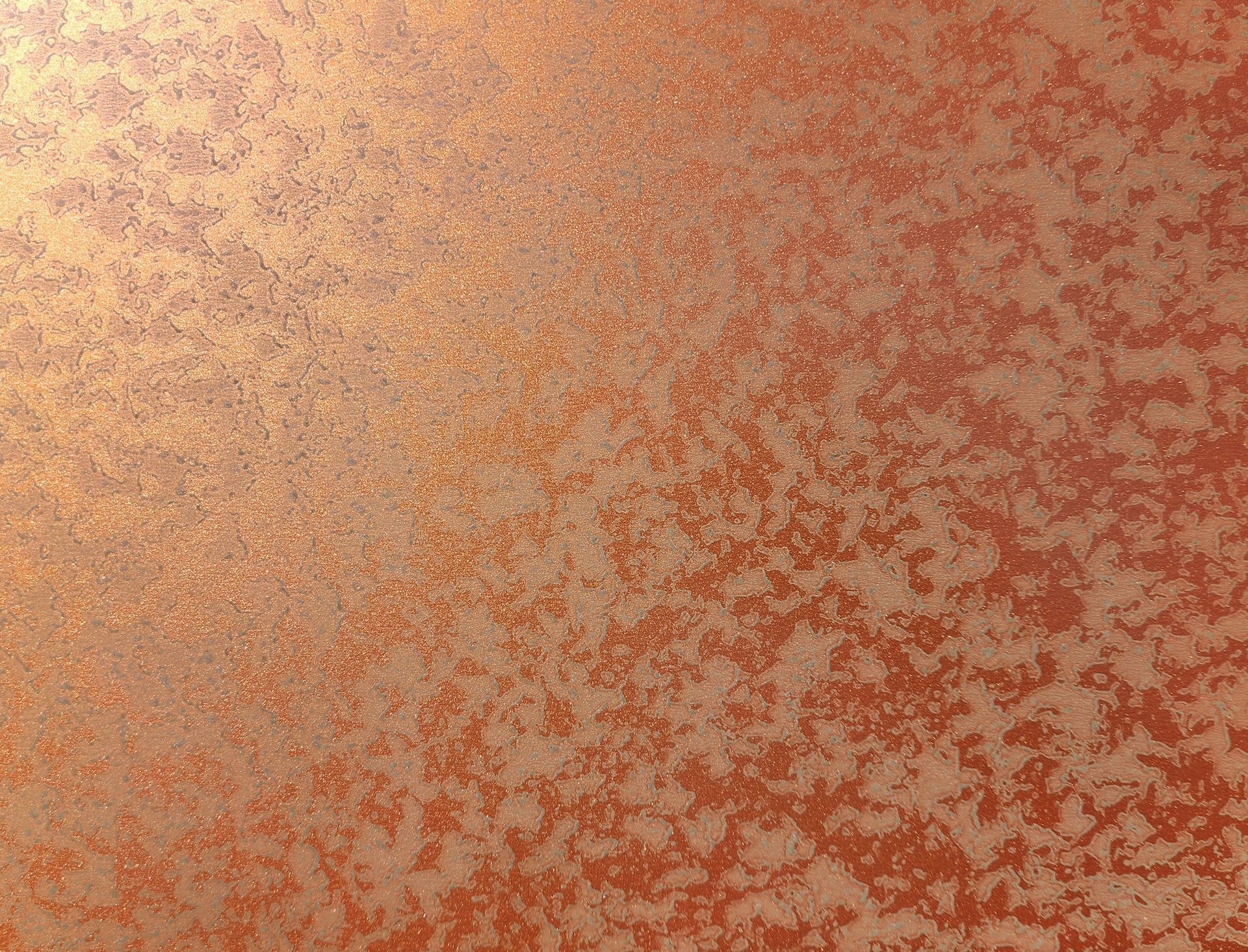 Orange-speckled textured surface with a soft gradient from light tan to rust