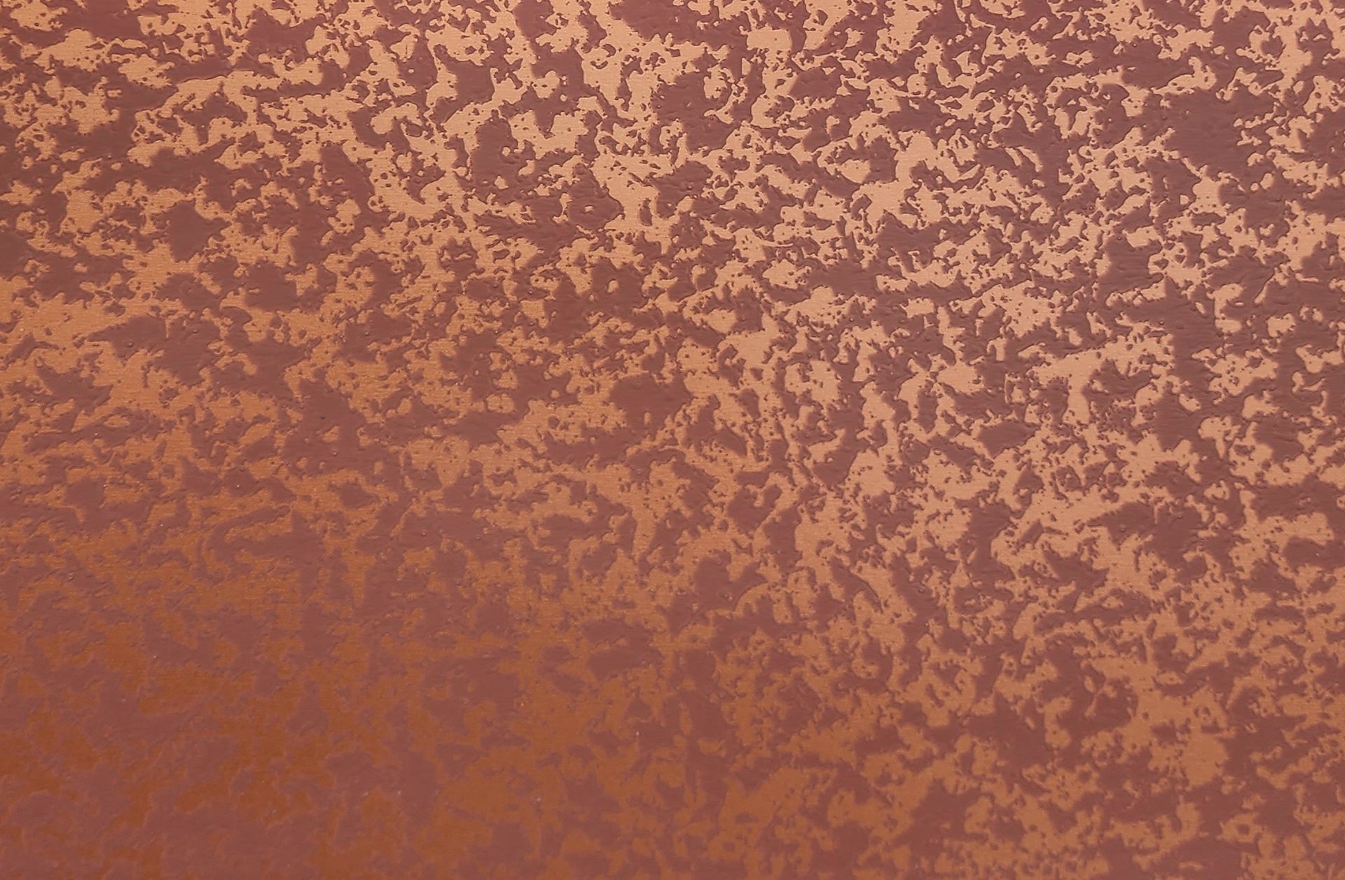 Abstract rust-colored textured surface with lighter speckled pattern and a darker band near the bottom