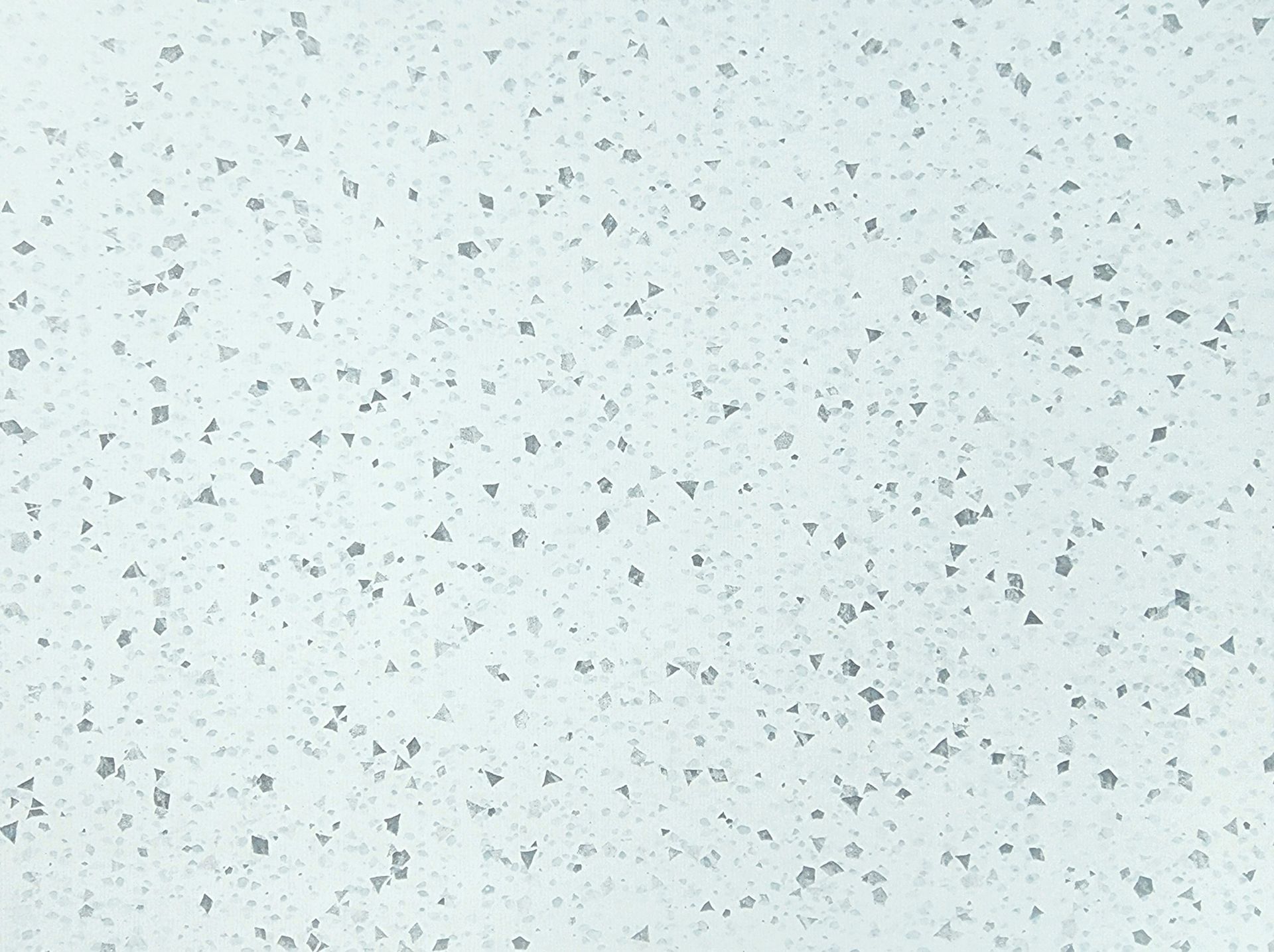 Light speckled off-white textured surface with scattered gray flecks