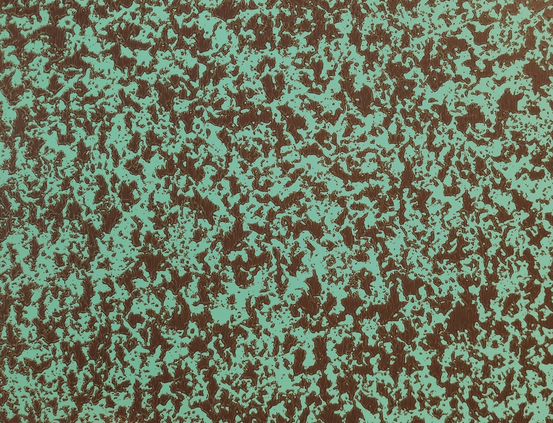 Abstract mottled texture with brown, green, and teal speckles