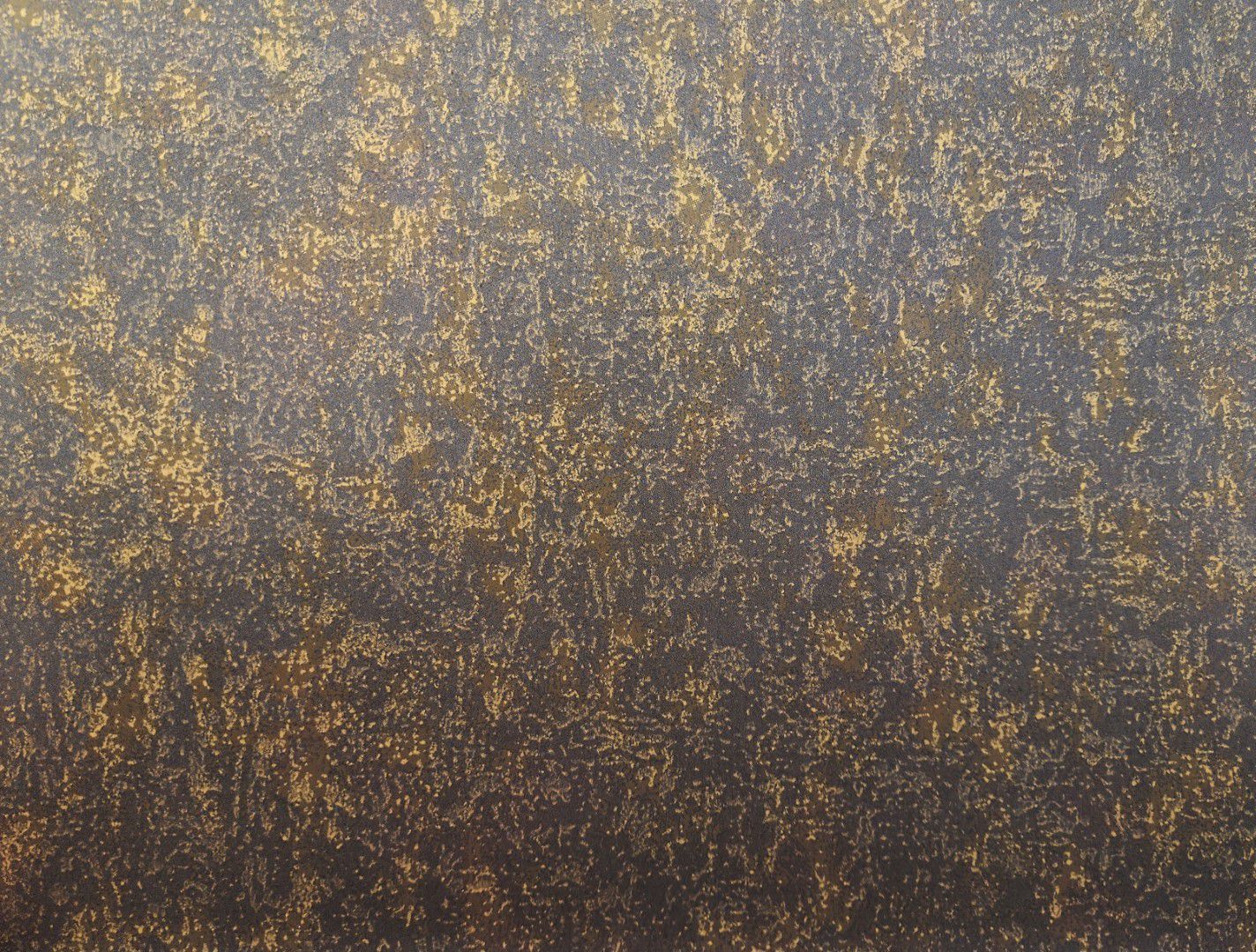 Abstract gold and brown speckled texture on a gray background