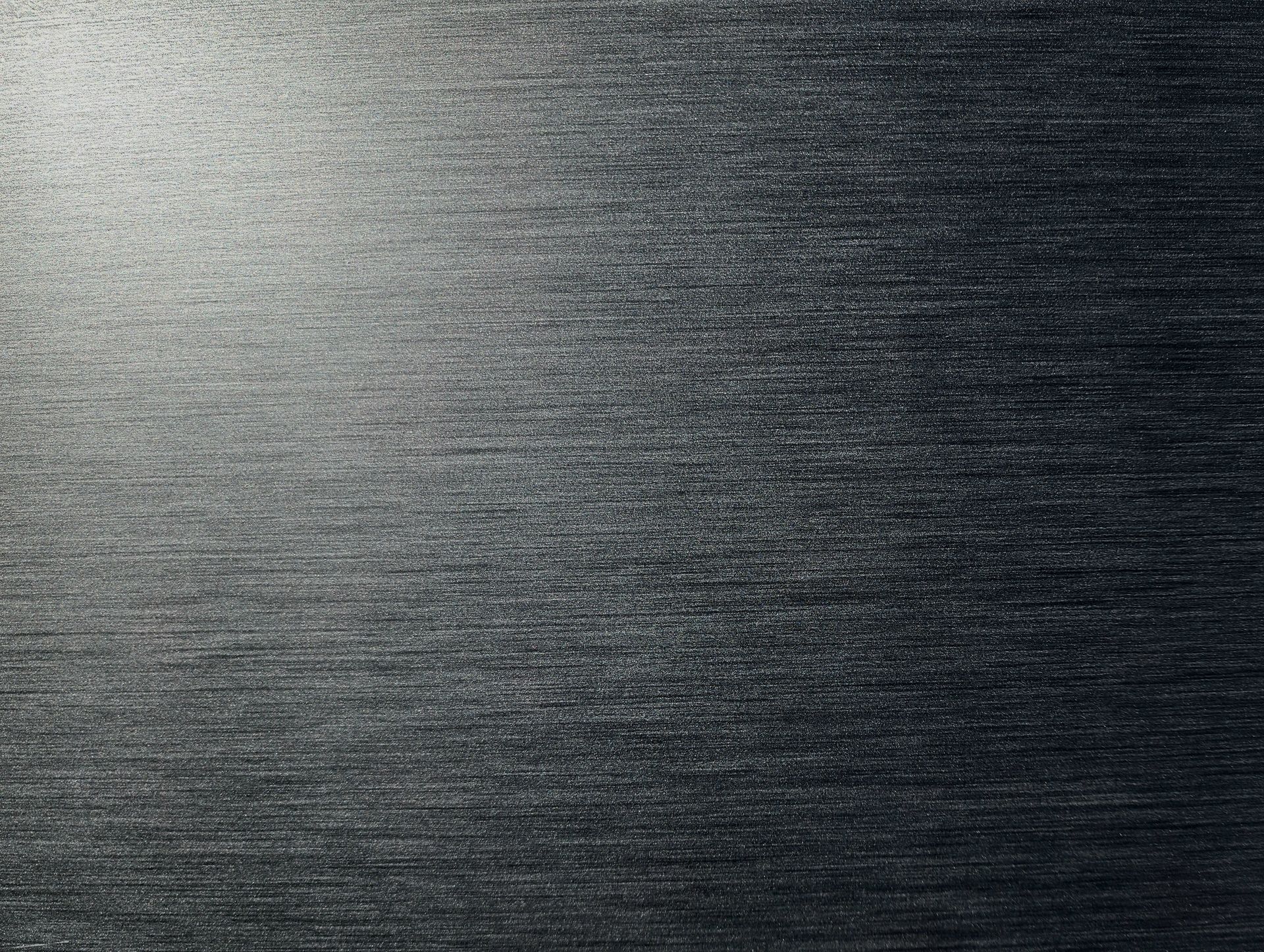 Dark gray brushed metal texture with horizontal grain patterns
