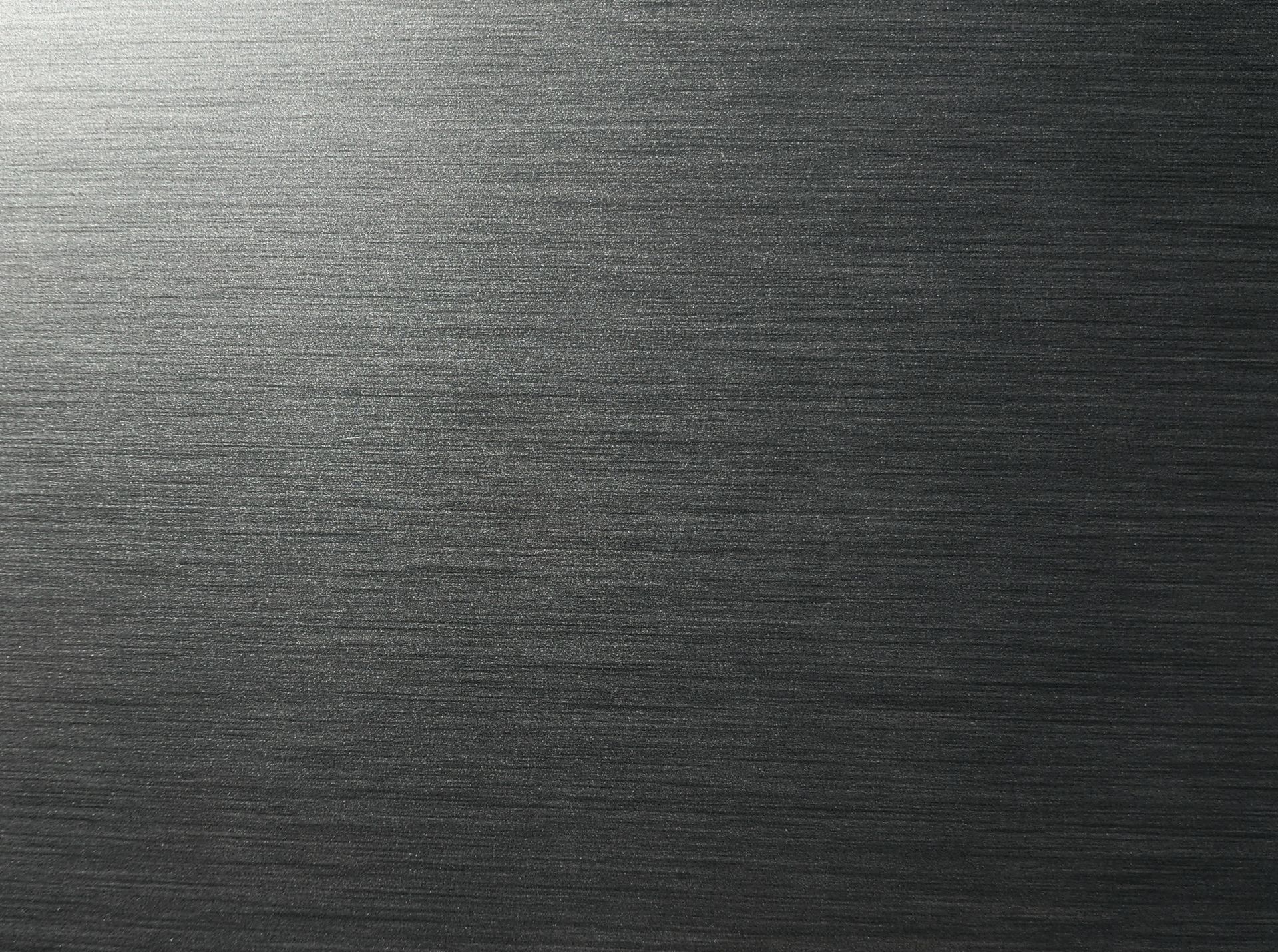 Dark gray brushed metal surface with fine horizontal texture