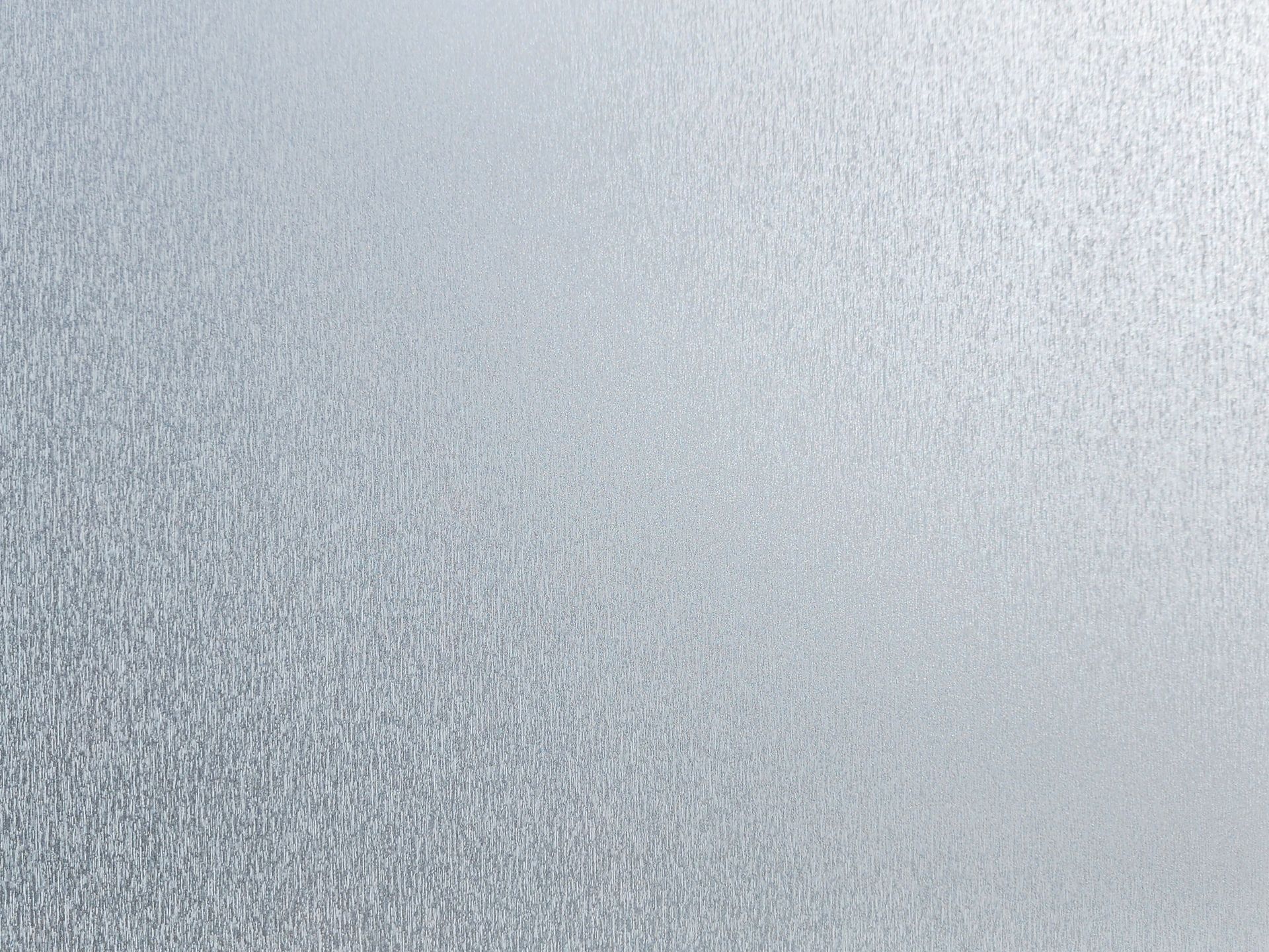 Close-up of a light gray textured surface with a subtle speckled pattern