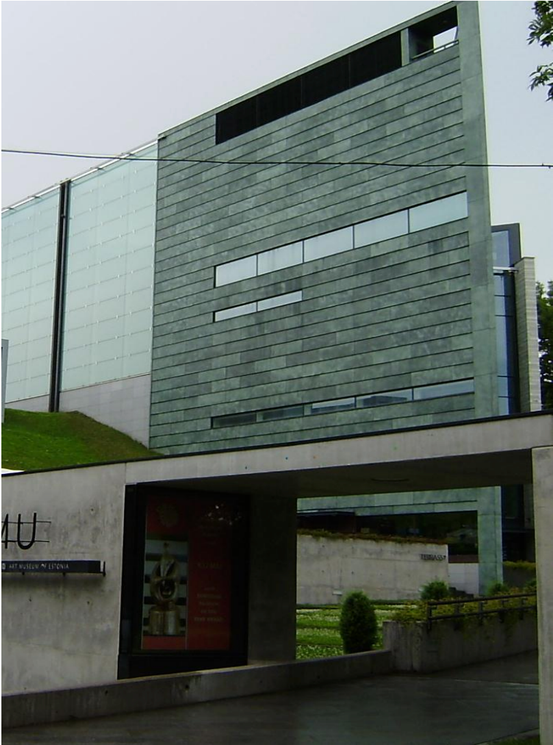 Modern gray office building with a large overhang and gated entrance
