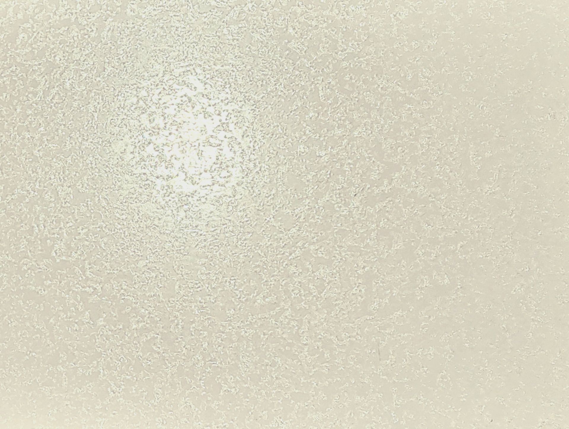 Blank beige textured surface with subtle speckling.