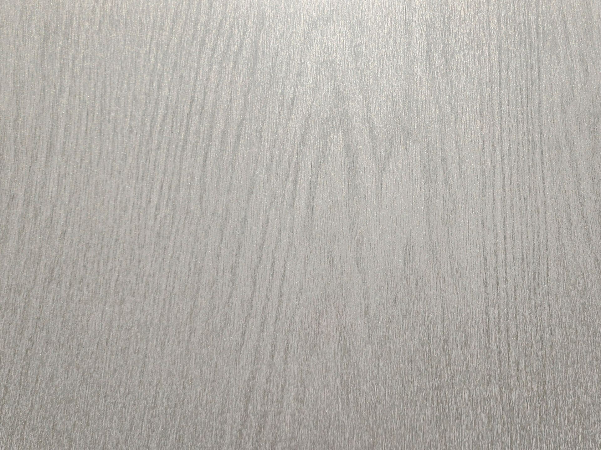 Close-up of a light gray textured surface with fine vertical streaks