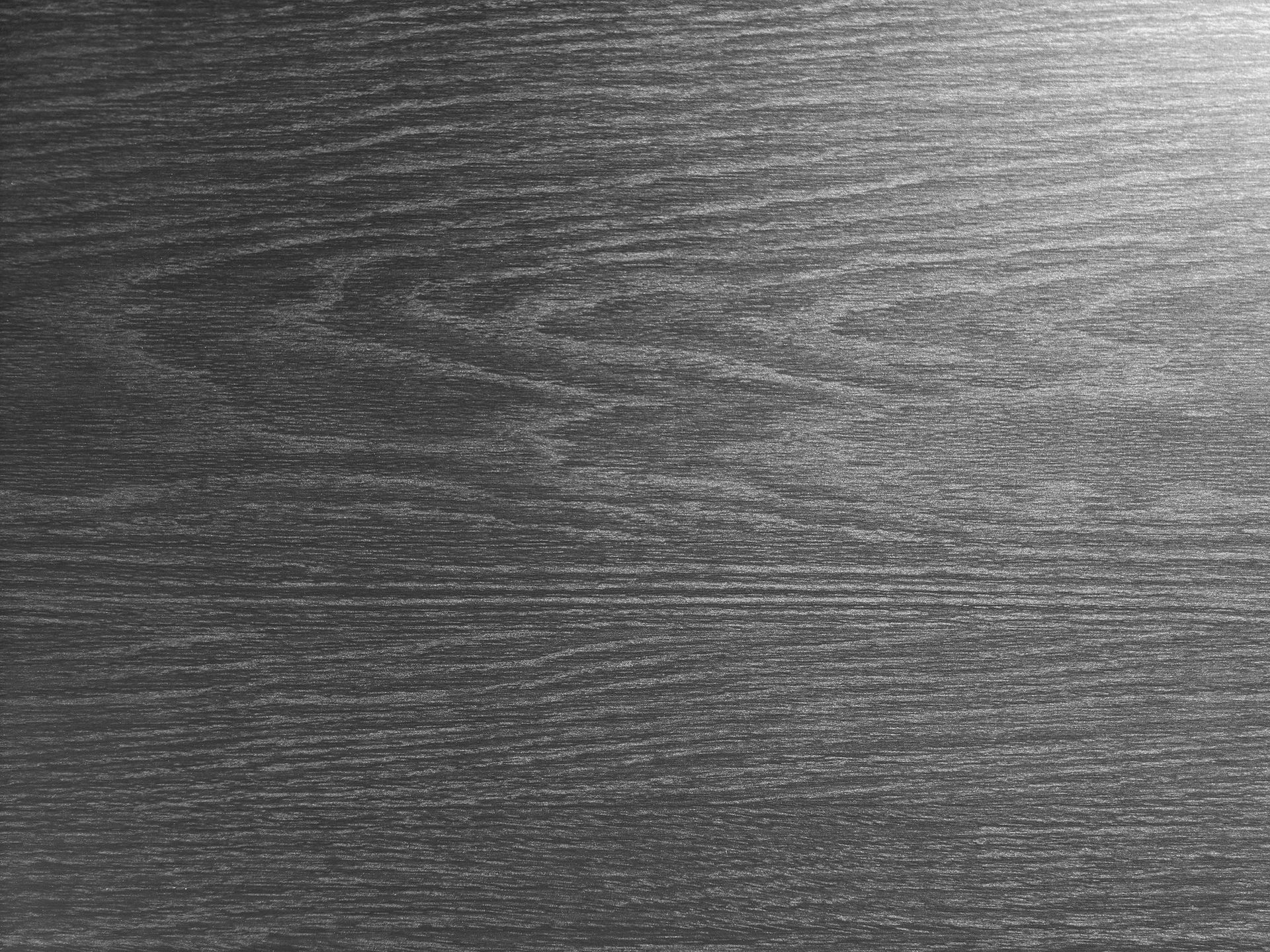 Close-up of a gray textured surface with fine horizontal grain patterns.
