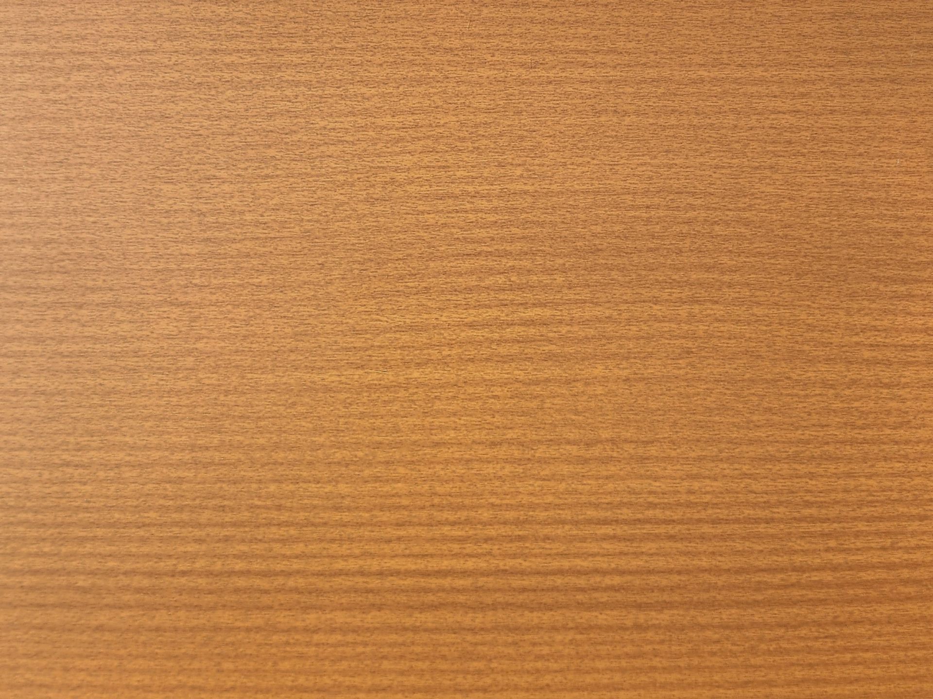 Close-up of a light brown wooden surface with visible horizontal grain.