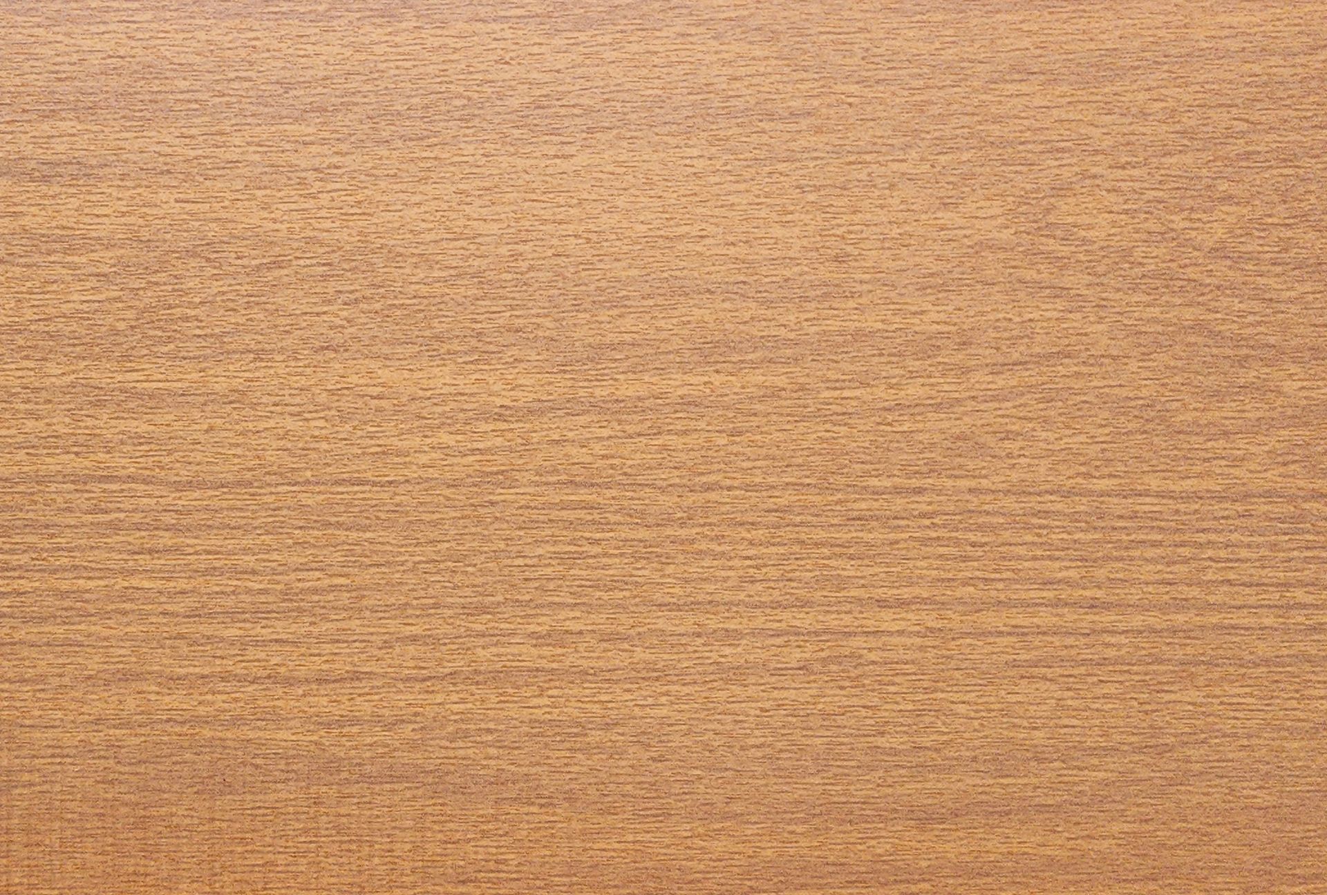 Close-up of a light brown wood grain surface with a smooth, uniform texture