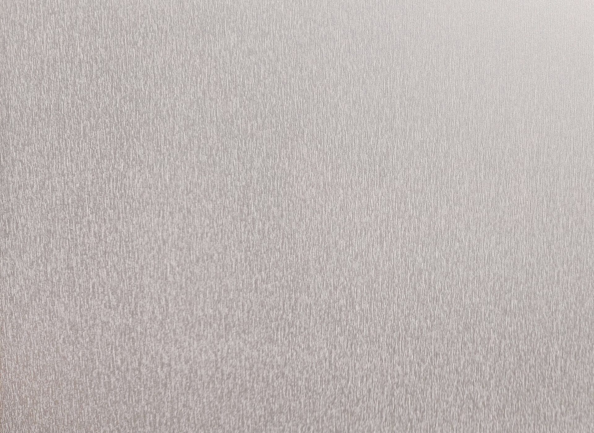 Close-up of a light gray textured surface with a subtle woven pattern.