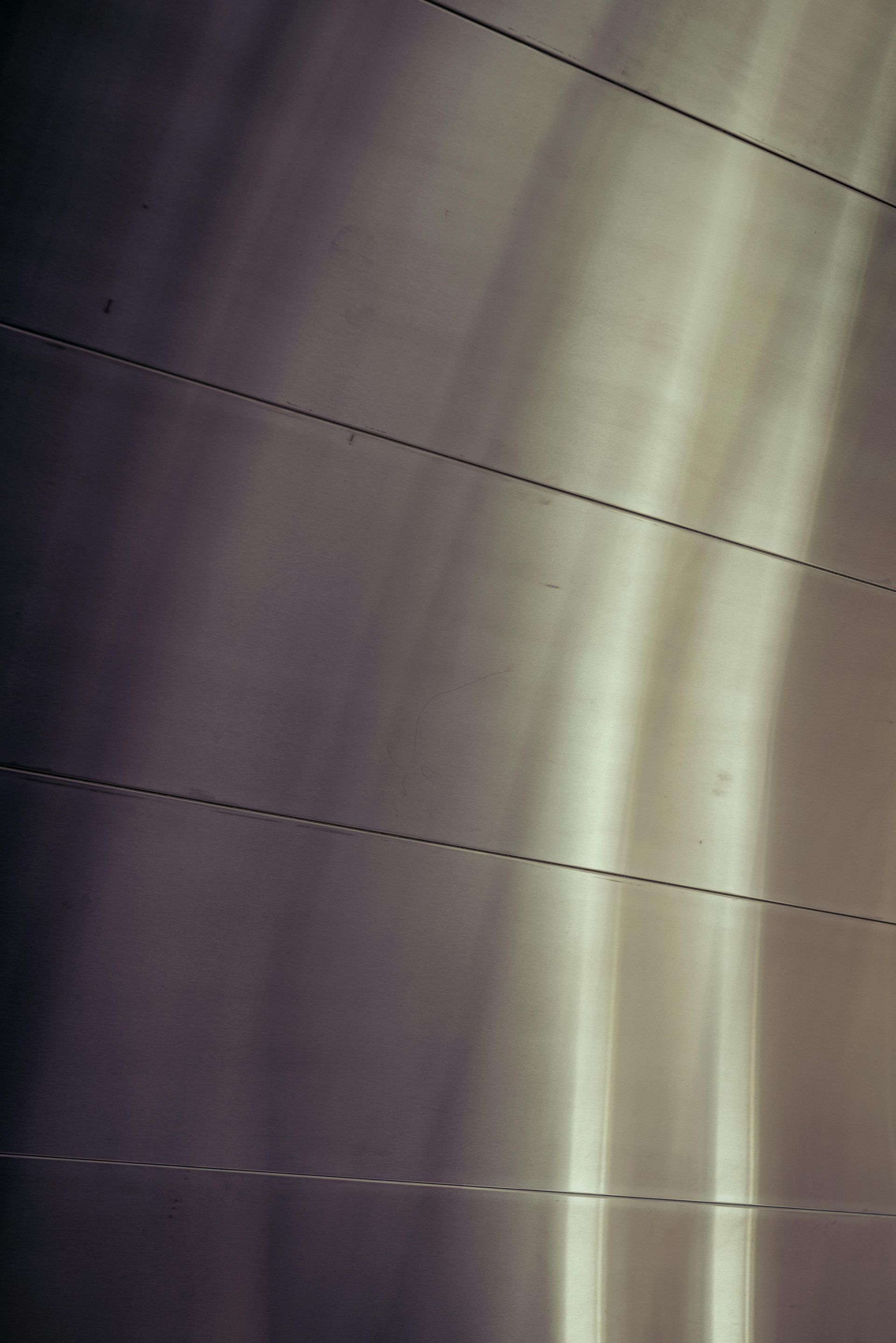 Abstract close-up of a pale curtain or surface with diagonal dark lines and soft light bands