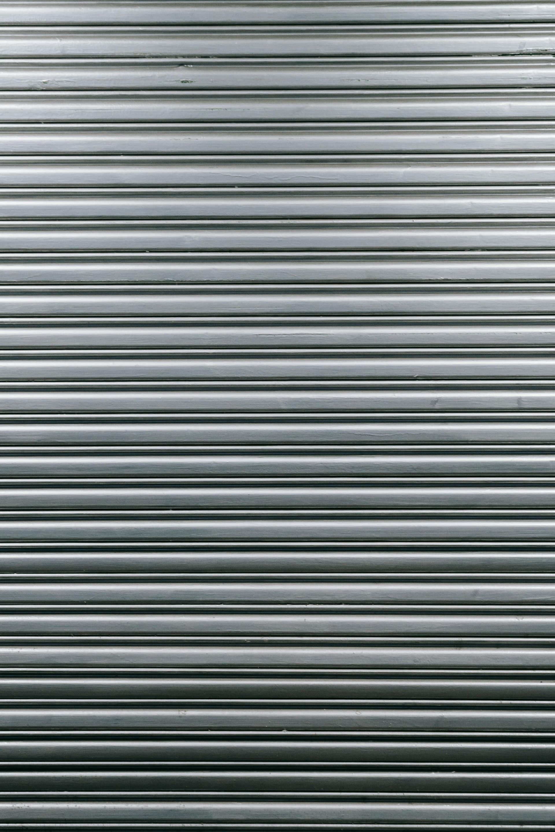 Closed gray metal roller shutter with horizontal slats