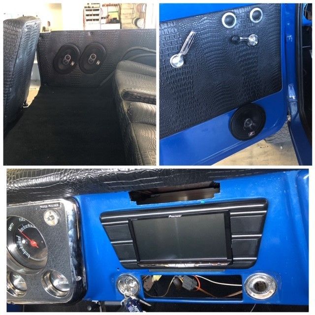 Blue custom car interior with black panels, chrome controls, and a central touchscreen dashboard