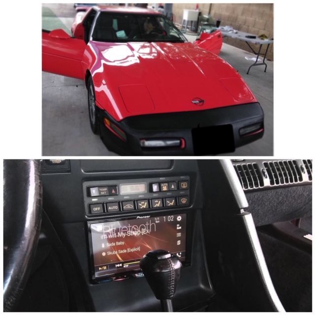 Red sports car with black trim; inset shows dashboard and touchscreen stereo inside the car.
