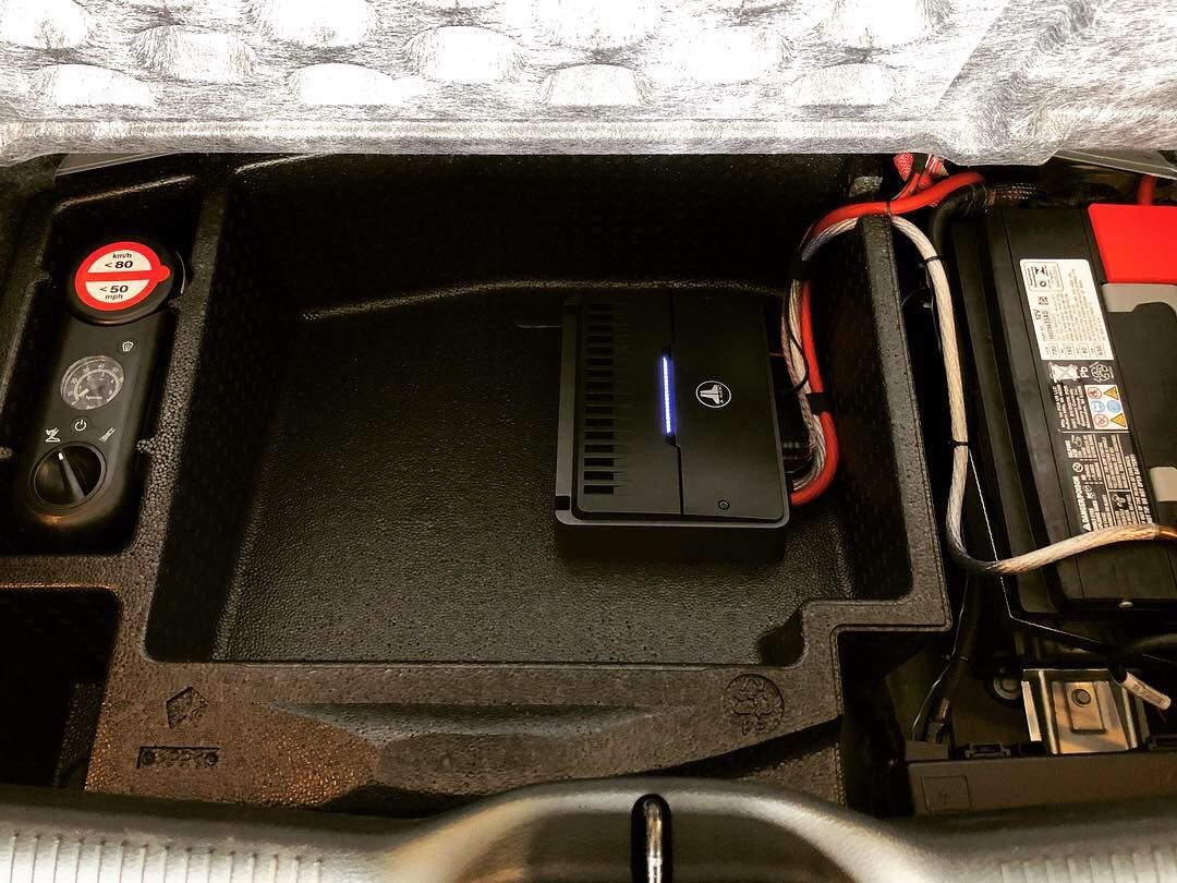Car trunk with a compact black device and battery pack secured in foam compartments