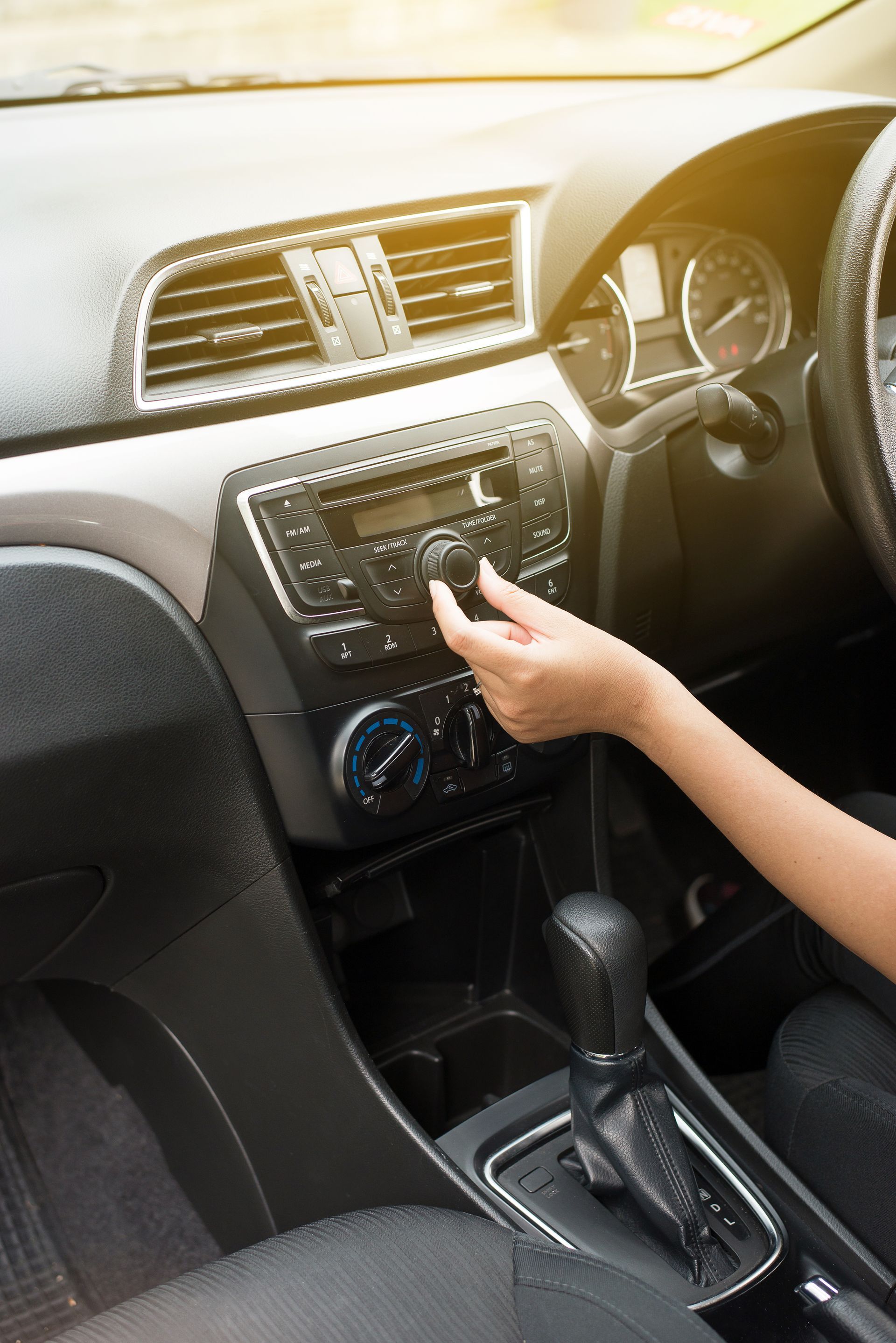 Hand woman touching the screen and turning on car radio system,Button on dashboard in car panel Hand woman touching the screen and turning on car radio system,Button on dashboard in car panel