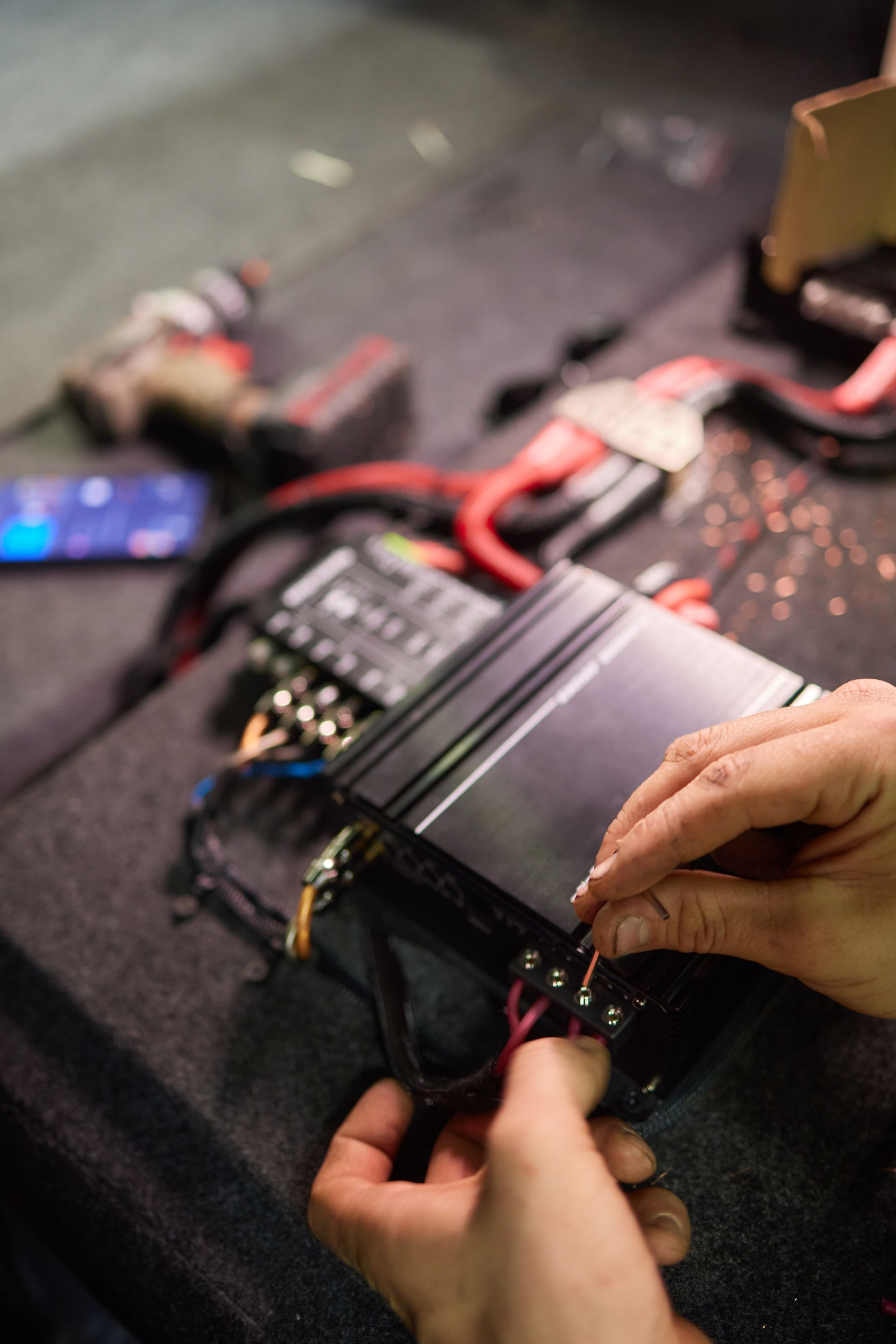 Technician installing the car audio processor Car audio installation concept. Technician installing the car audio processor Car audio installation concept.