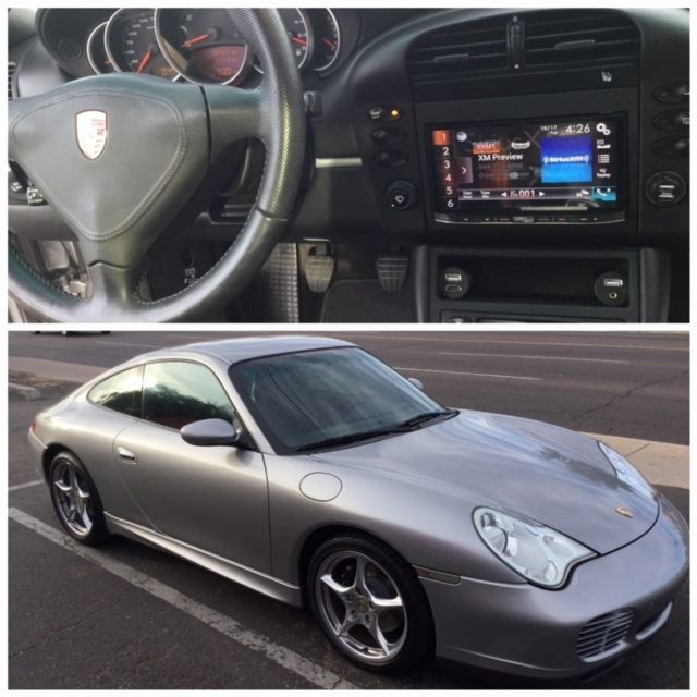 Silver Porsche coupe, with dashboard and infotainment close-up, parked outdoors on a road.