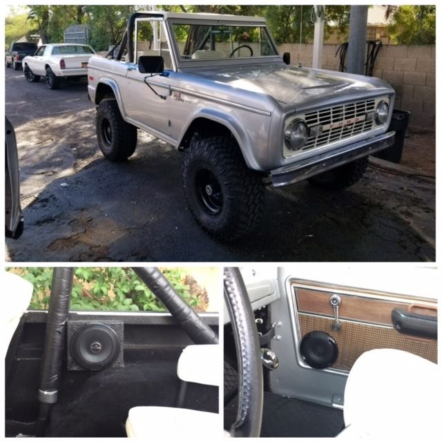 Vintage silver off-road SUV with black wheels, plus close-ups of the interior door and speaker.