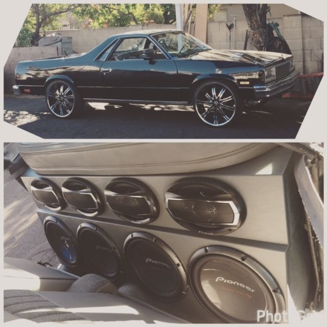 Black classic lowrider coupe with oversized chrome wheels; inset shows custom Pioneer speaker audio setup.