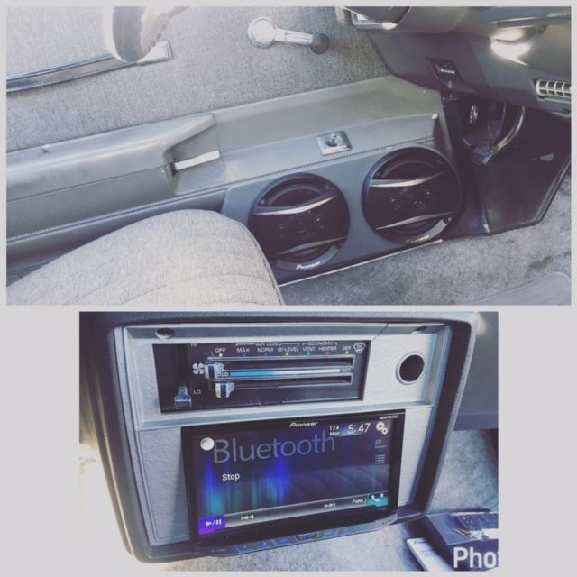 Car interior with aftermarket stereo and Bluetooth touchscreen display under the dashboard.