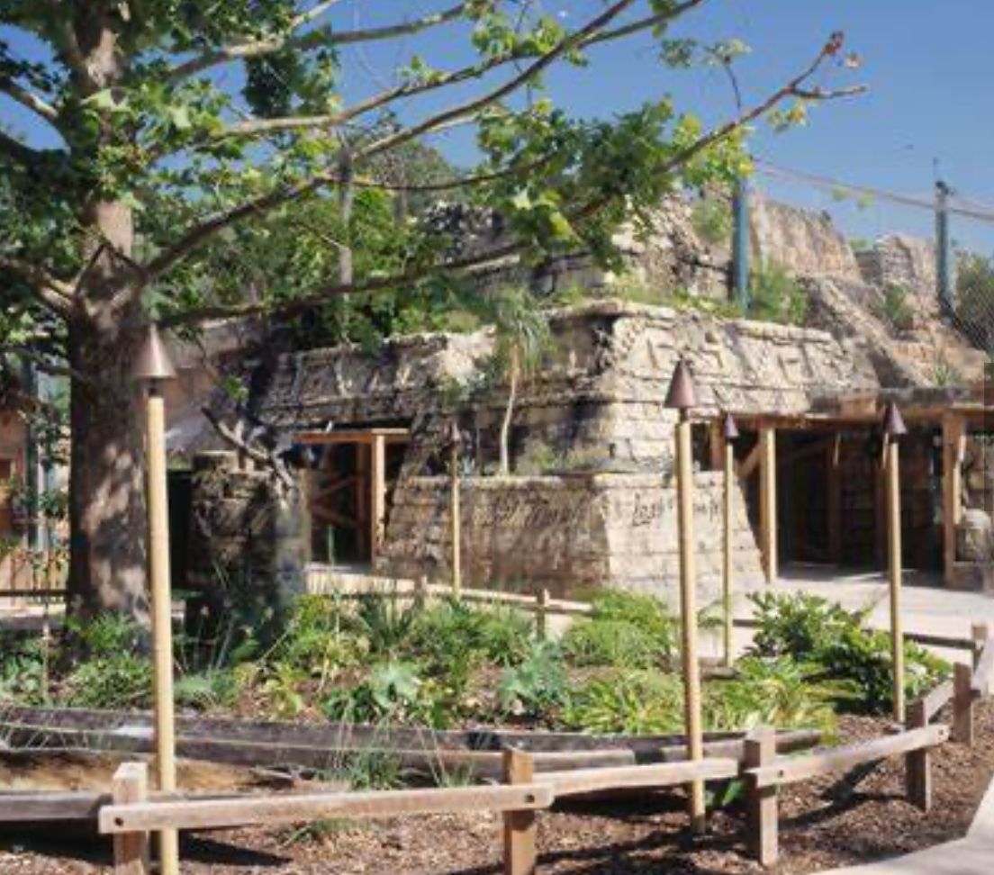 A stone building with a wooden fence around it