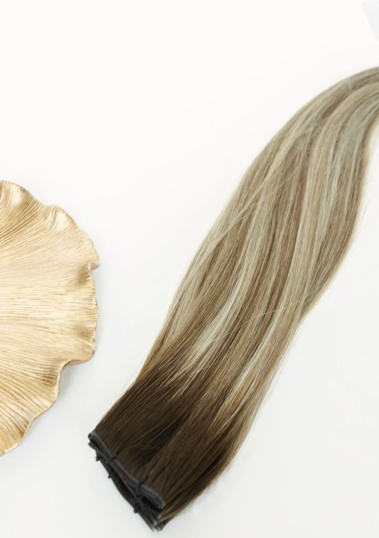 Blonde-to-brown ombré hair extension clip-in on a white background