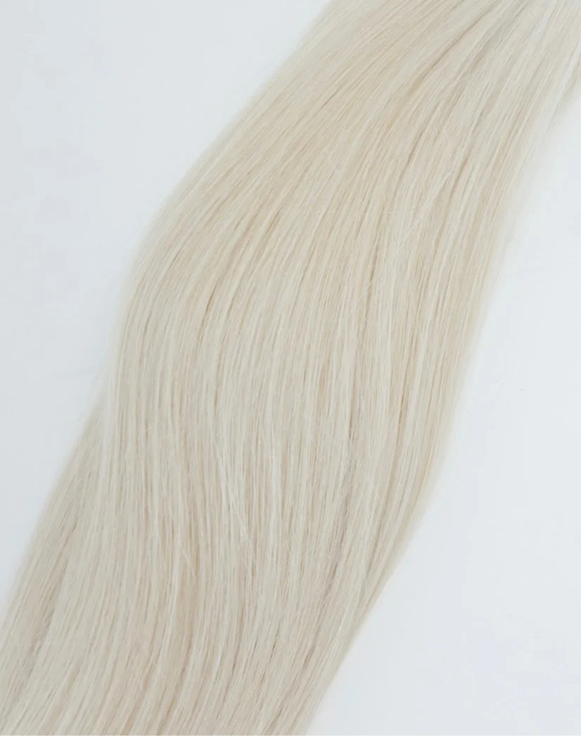 Light blonde hair strands against a white background