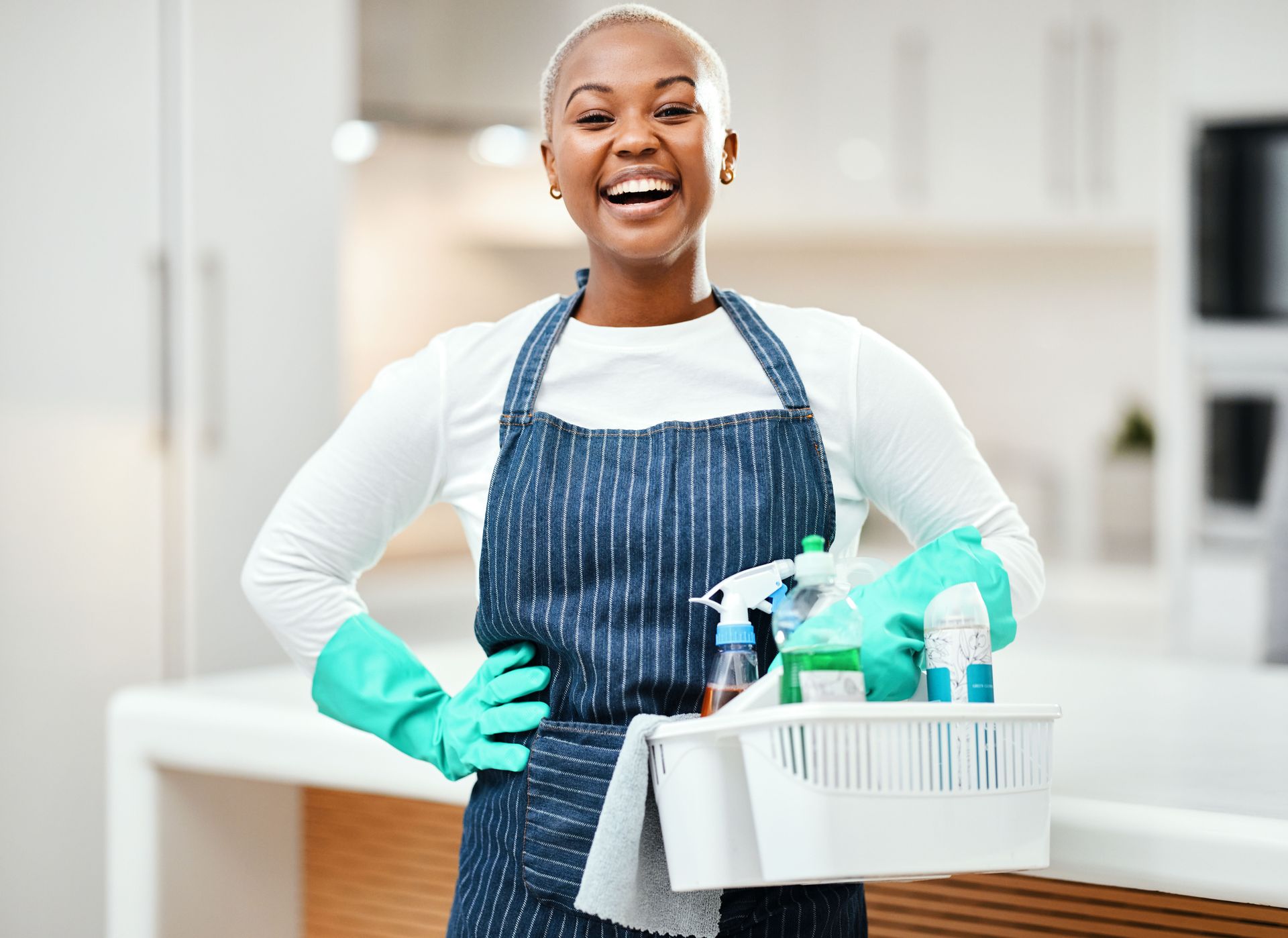 Person wearing blue gloves cleans a window with a squeegee. Person wearing blue gloves cleans a window with a squeegee.