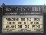Church sign reading “Preaching the Old Book, Singing the Old Hymns, Walking the Old Paths.”