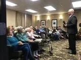 Audience listening to a speaker presenting in a conference room