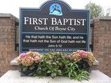 First Baptist Church of Boyce City sign with flowers in front and Bible verse text