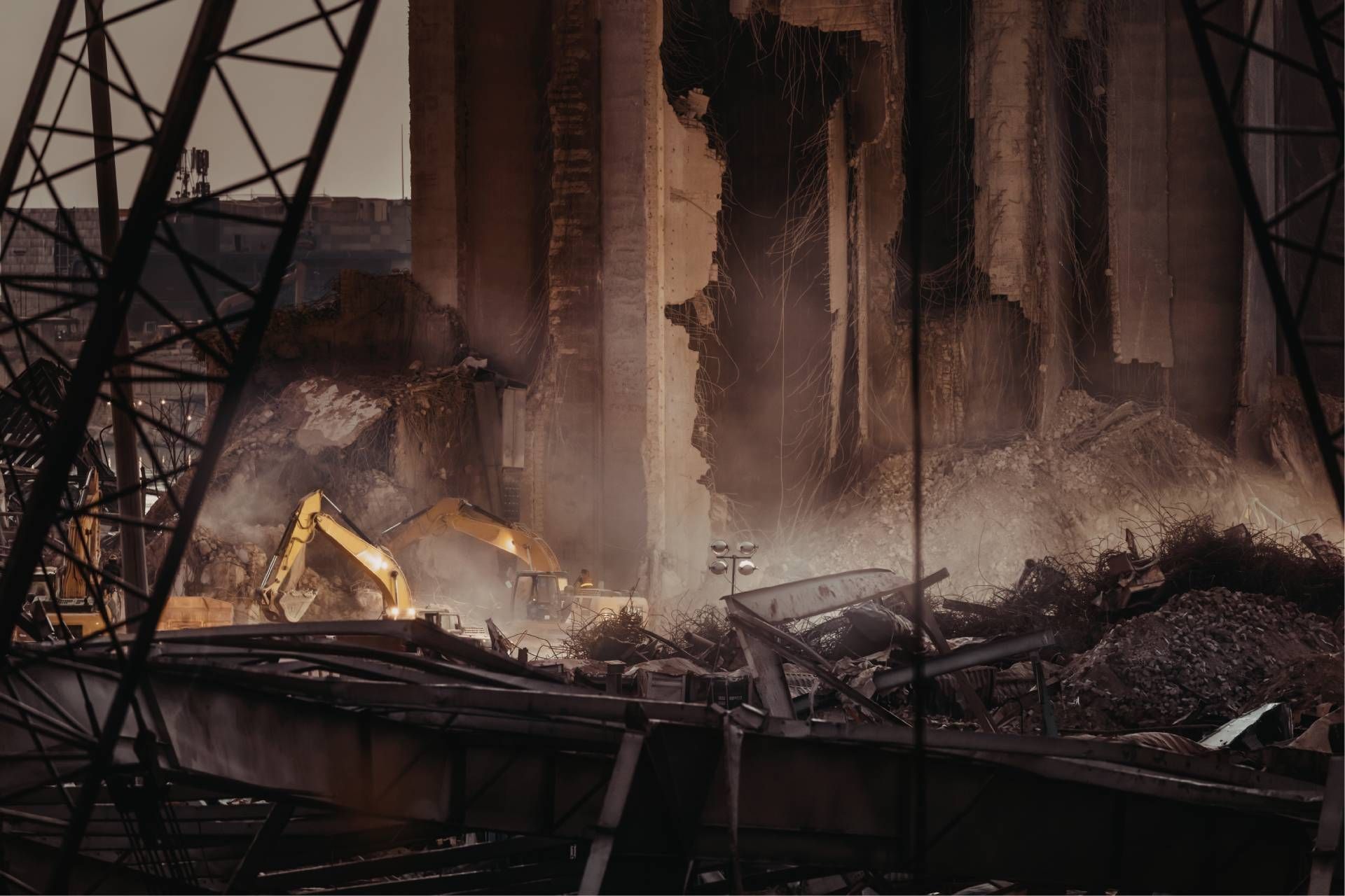 Industrial fire with heavy smoke and debris at a damaged metal structure