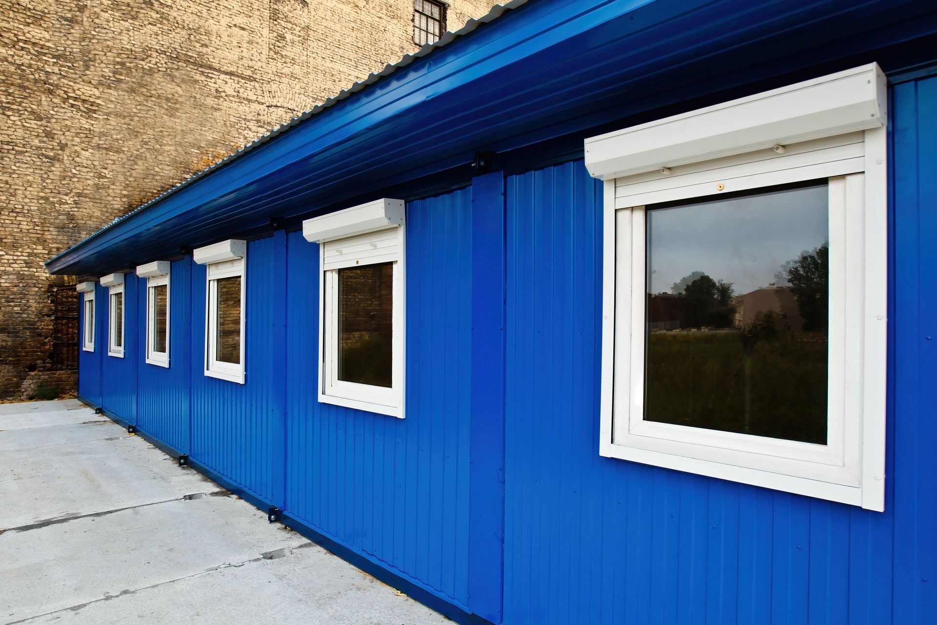 The Front Door of a House With a Sliding Glass Door and a Walkway Leading to It — Whitsunday Screens & Grilles In Cannonvale, QLD