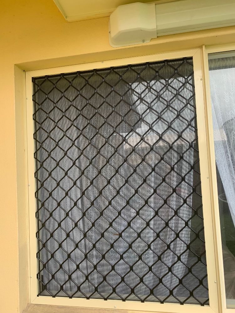 The Front Door of a House With a Sliding Glass Door — Whitsunday Screens & Grilles In Proserpine, QLD