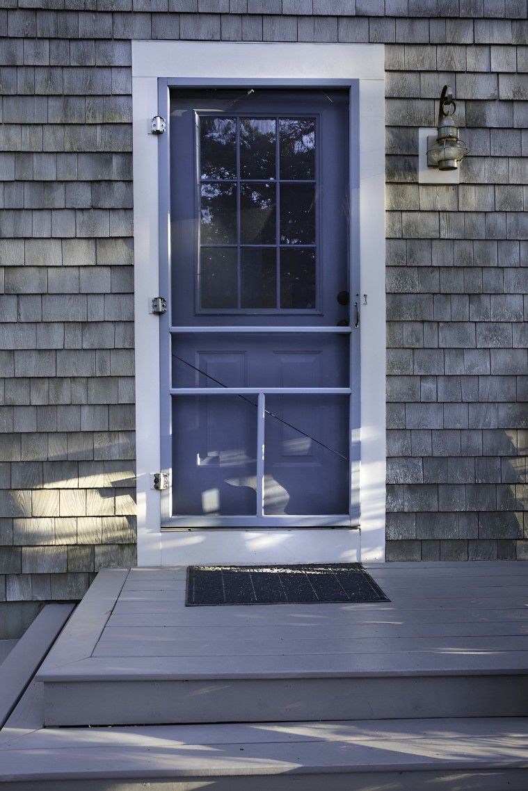 A Blue Screen Door is on a Brick Building — Whitsunday Screens & Grilles In Bowen, QLD