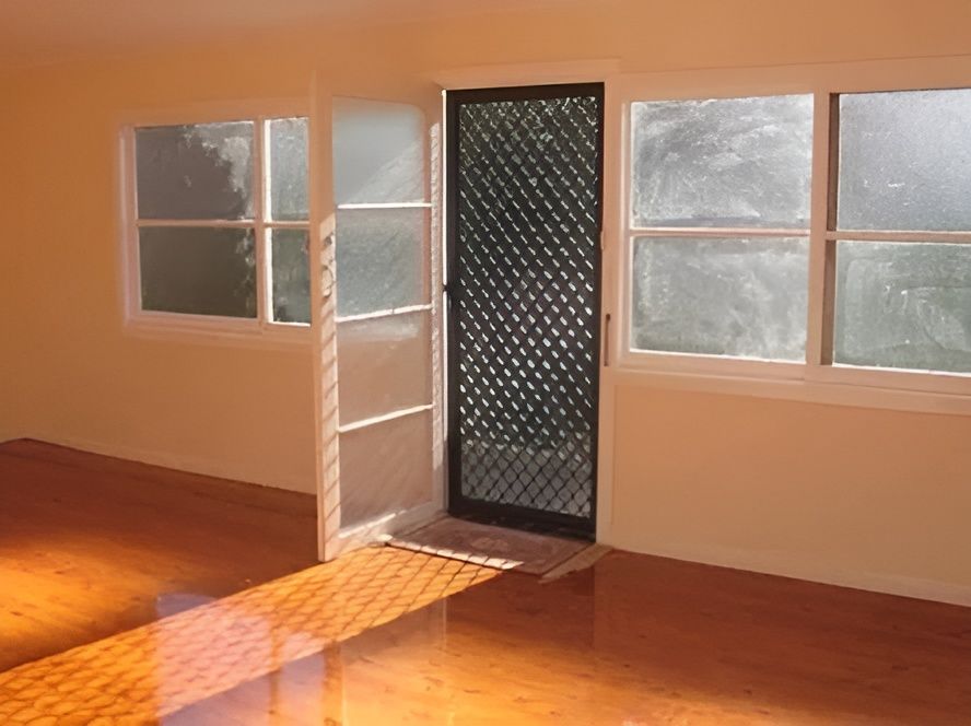 An Empty Room With a Sliding Glass Door and Two Windows — Whitsunday Screens & Grilles In Cannonvale, QLD