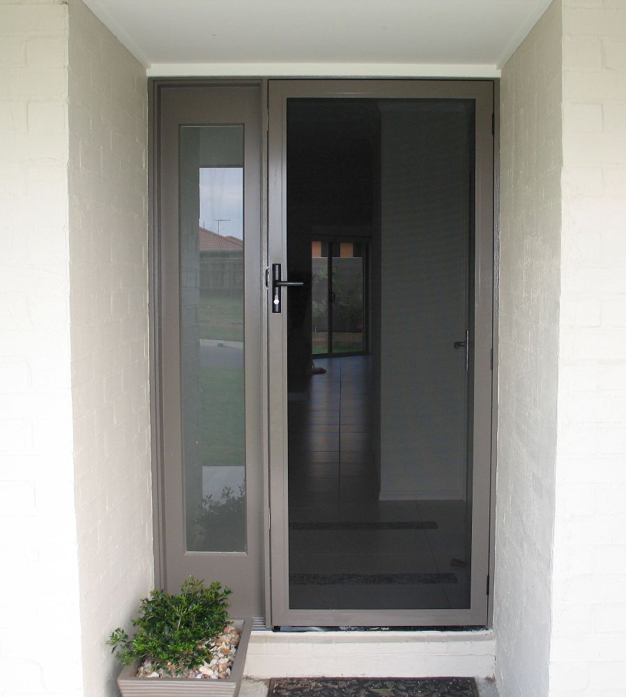The Front Door of a House With a Sliding Glass Door — Whitsunday Screens & Grilles In Proserpine, QLD