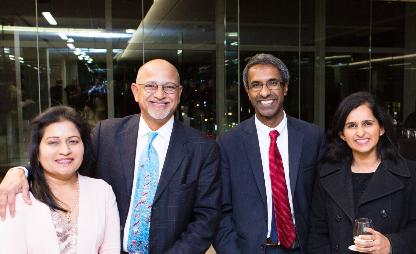 A group of people in suits and ties are posing for a picture.
