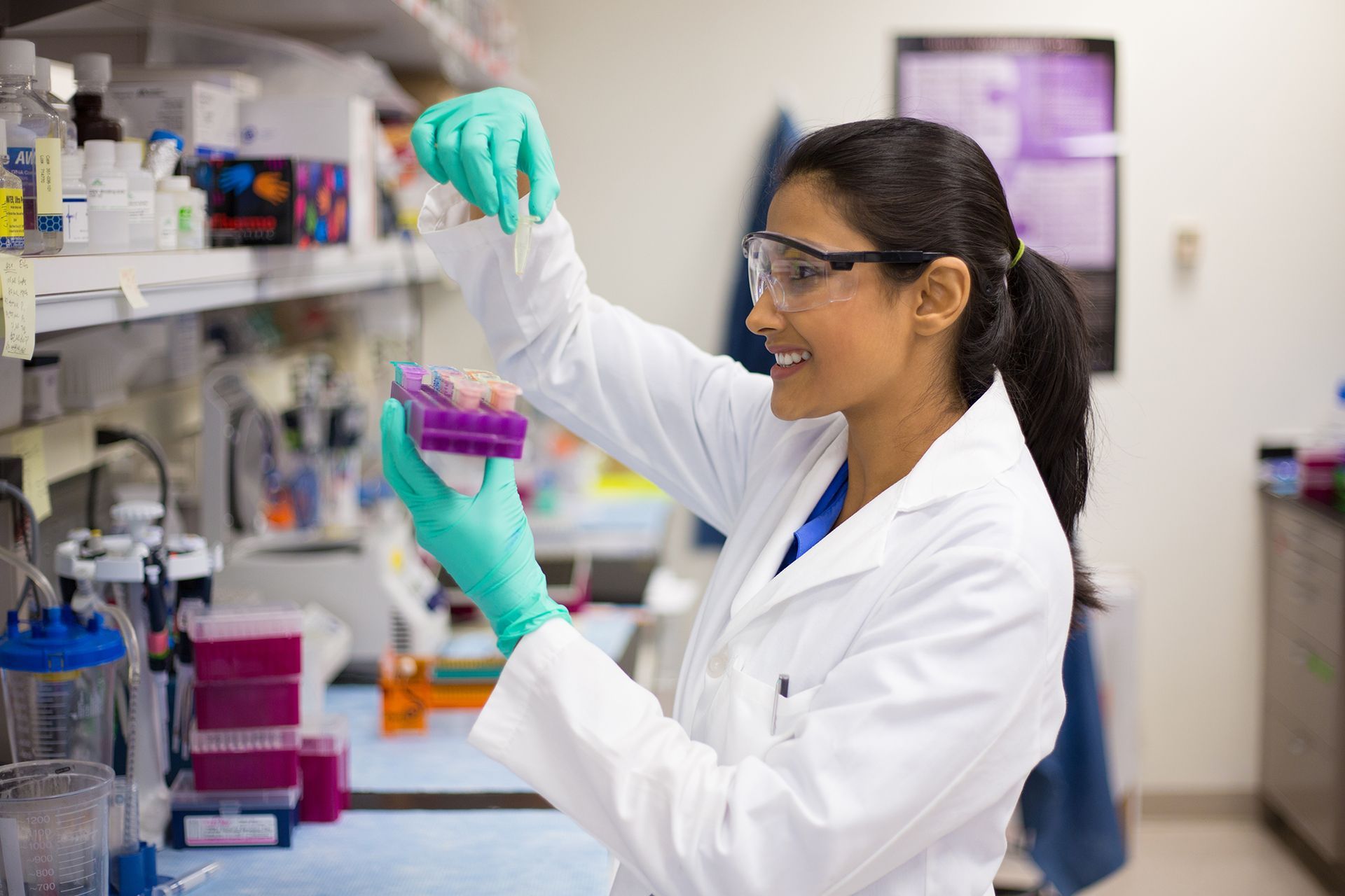 A woman in a lab coat is working in a laboratory.