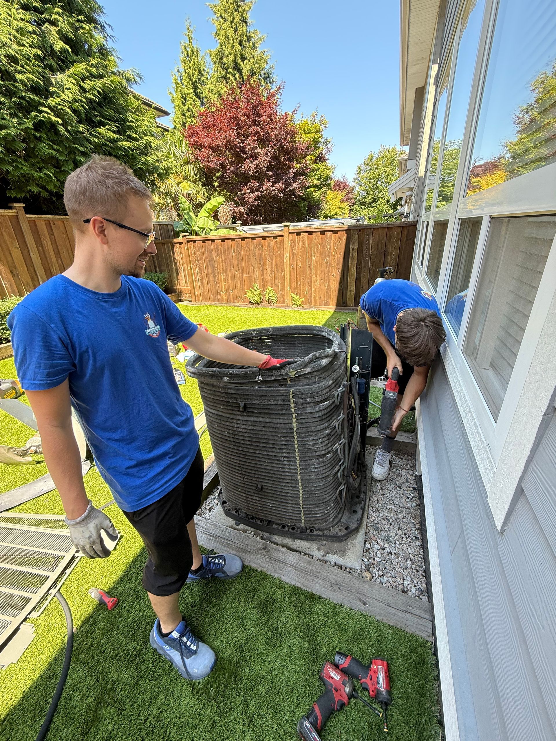 Penguin HVAC installers installing heat pump in Vancouver