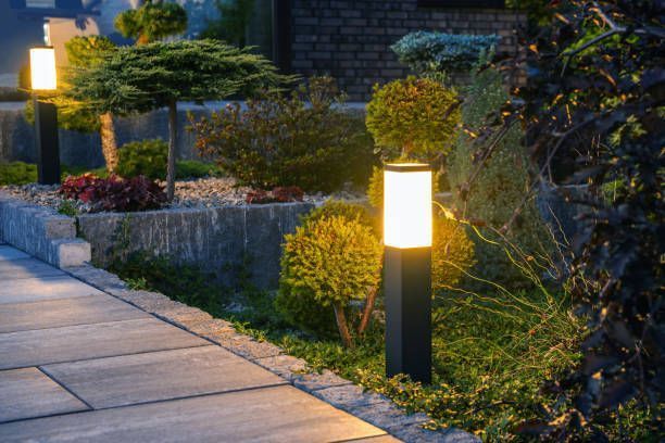 Lit pathway lights along a landscaped garden walkway at dusk