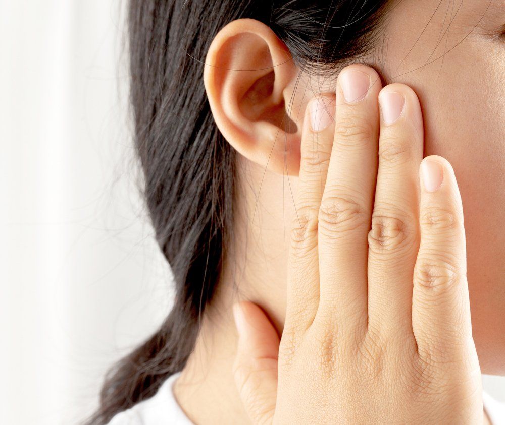 Woman With Earache — Belfast, ME — Hearing Solutions Woman With Earache — Belfast, ME — Hearing Solutions