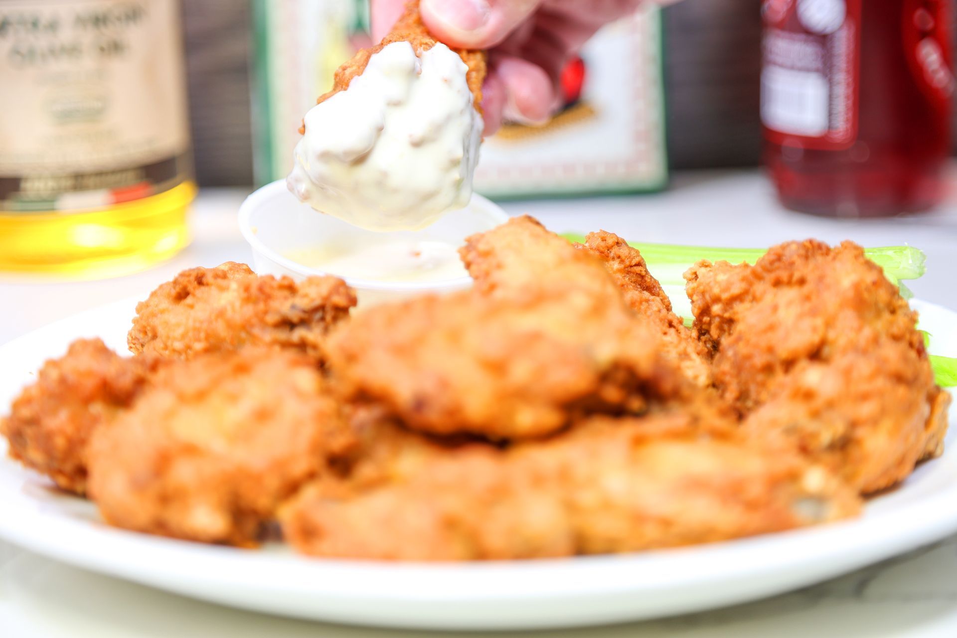 Plate of golden fried chicken pieces with a scoop of mashed potatoes and gravy on the side